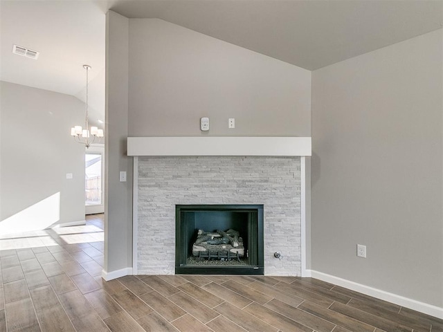 details featuring a notable chandelier and a stone fireplace