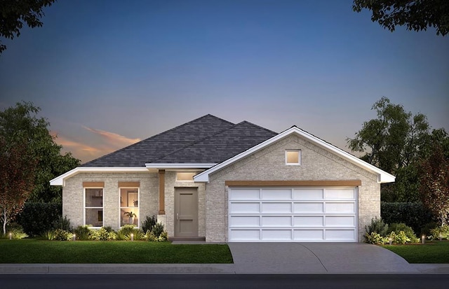 view of front facade with a garage and a yard