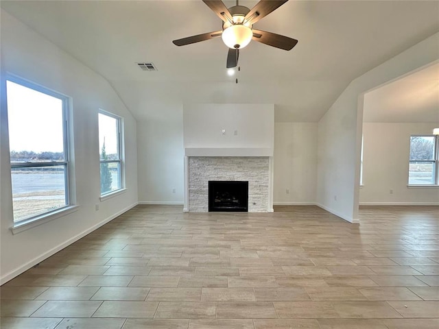 unfurnished living room with a fireplace, ceiling fan, and lofted ceiling