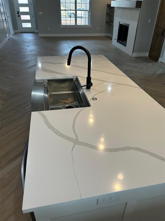 room details with light stone counters and sink