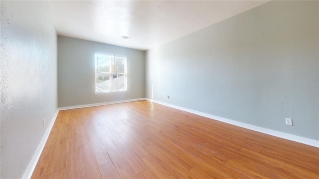 spare room with light hardwood / wood-style flooring