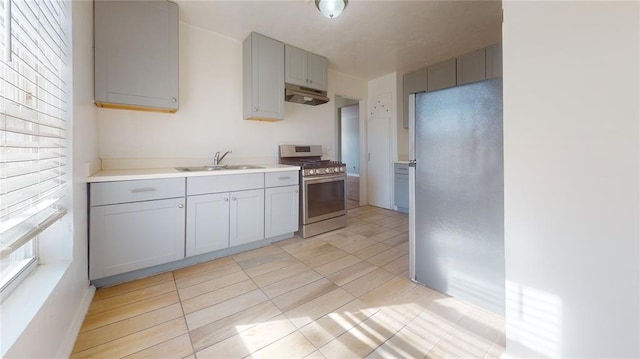 kitchen with light tile patterned floors, stainless steel appliances, gray cabinetry, and sink