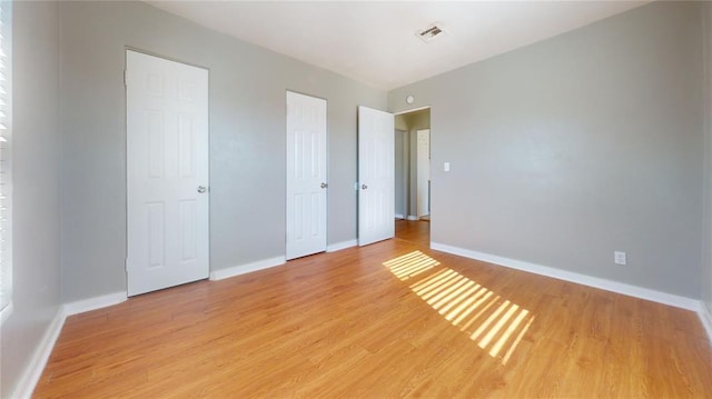 unfurnished bedroom featuring light wood-type flooring