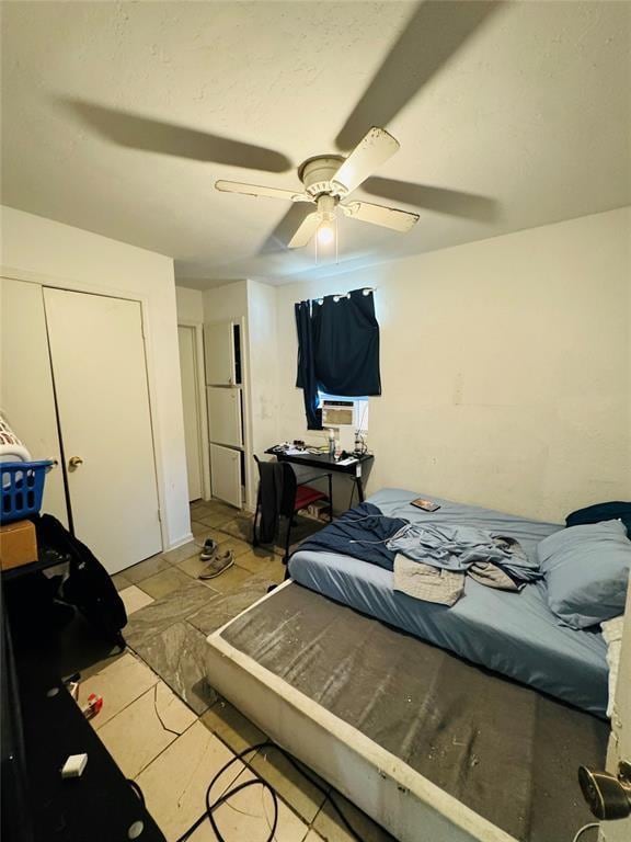 bedroom featuring a ceiling fan and a closet