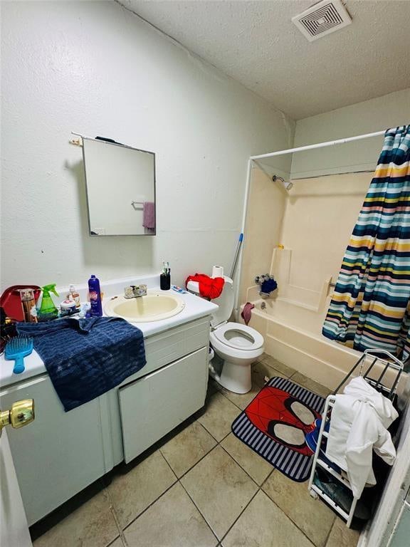 bathroom featuring visible vents, toilet, tile patterned floors, shower / bath combo with shower curtain, and a textured ceiling