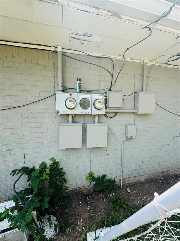 exterior details with electric meter and brick siding