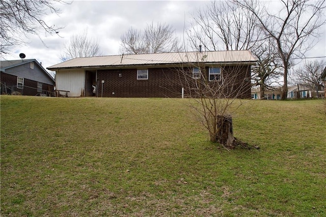 rear view of house featuring a lawn