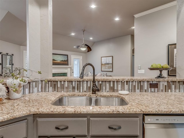 kitchen with dishwasher, light stone counters, open floor plan, a sink, and recessed lighting