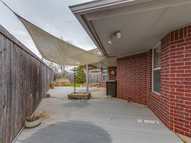 view of patio / terrace featuring fence and a wooden deck