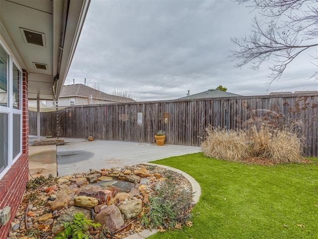 view of yard featuring a fenced backyard and a patio