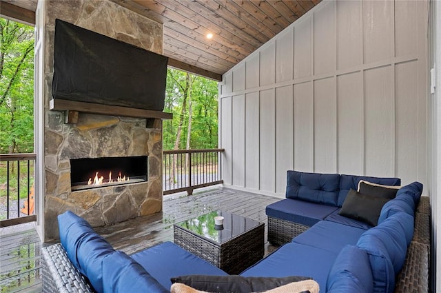 exterior space featuring an outdoor stone fireplace, hardwood / wood-style floors, wood ceiling, and vaulted ceiling