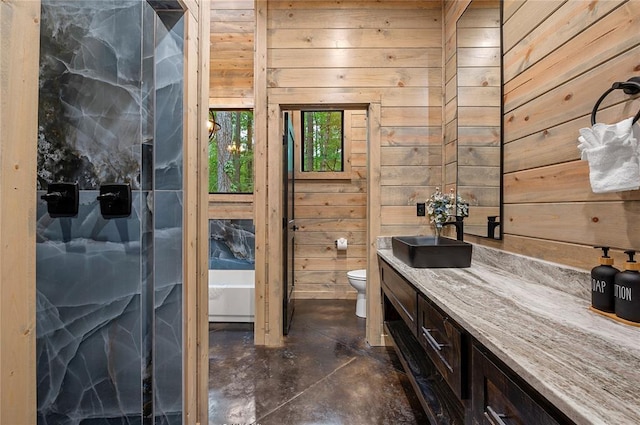 bathroom with vanity, toilet, and wooden walls