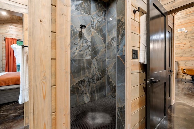 bathroom featuring concrete floors and wooden walls