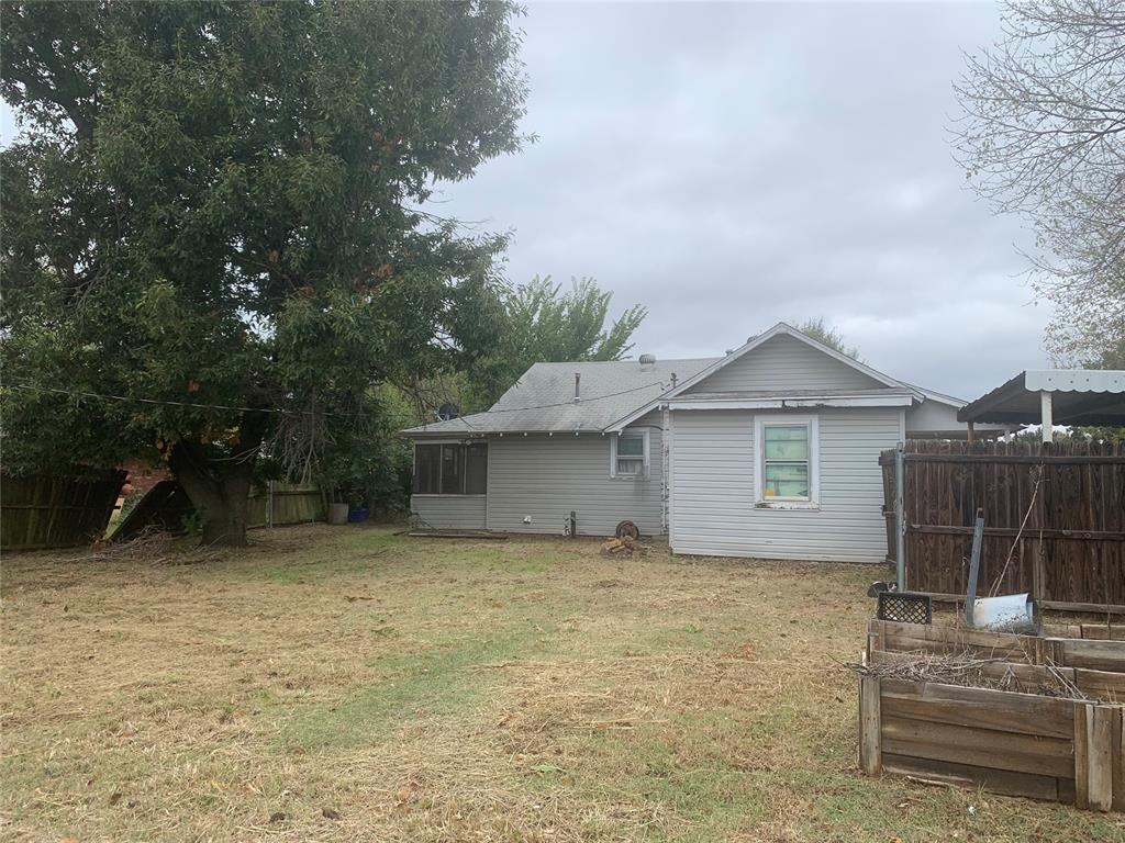 rear view of house with a yard