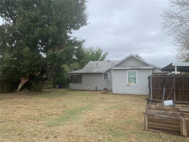 rear view of house with a yard