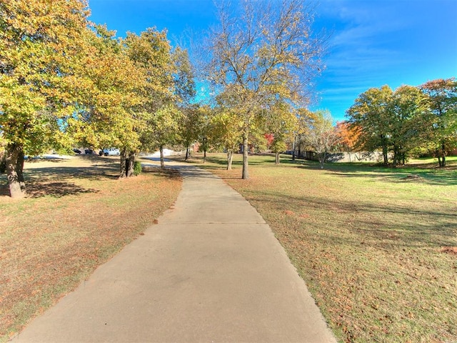 view of property's community with a lawn