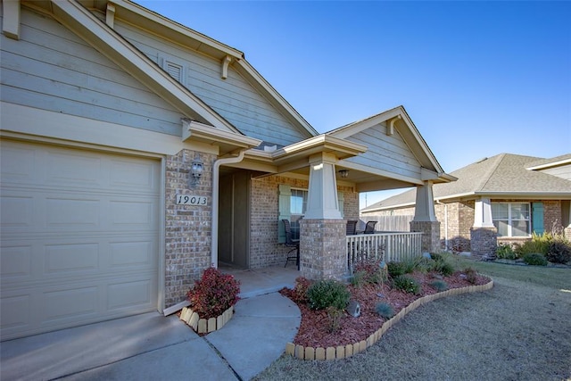 doorway to property with a porch and a garage