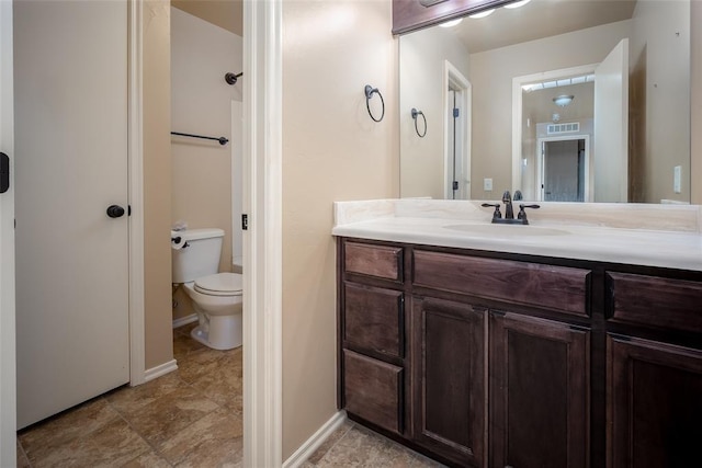 bathroom featuring tile patterned floors, vanity, and toilet