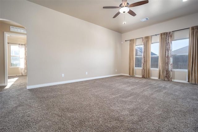 carpeted spare room featuring ceiling fan