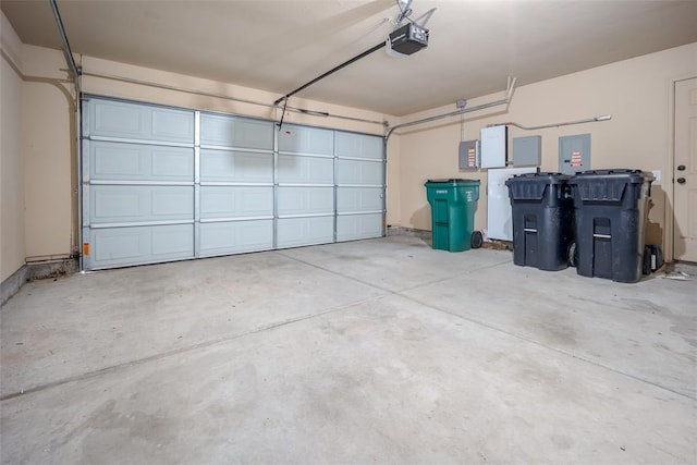 garage with electric panel and a garage door opener