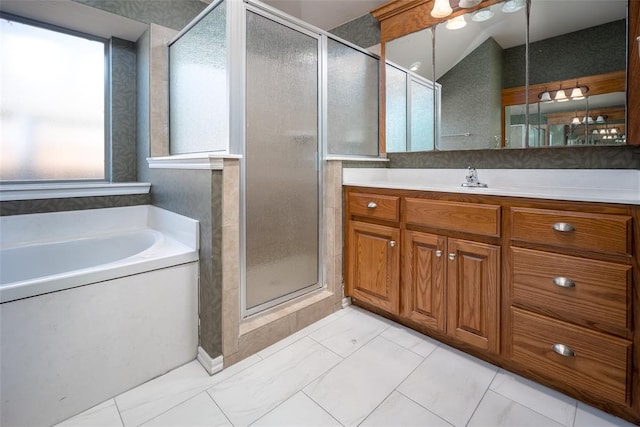 bathroom featuring vanity and independent shower and bath