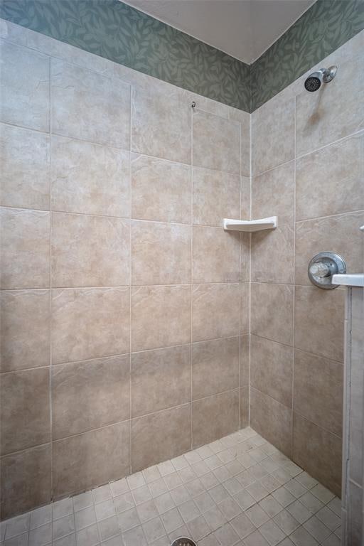 bathroom with a tile shower