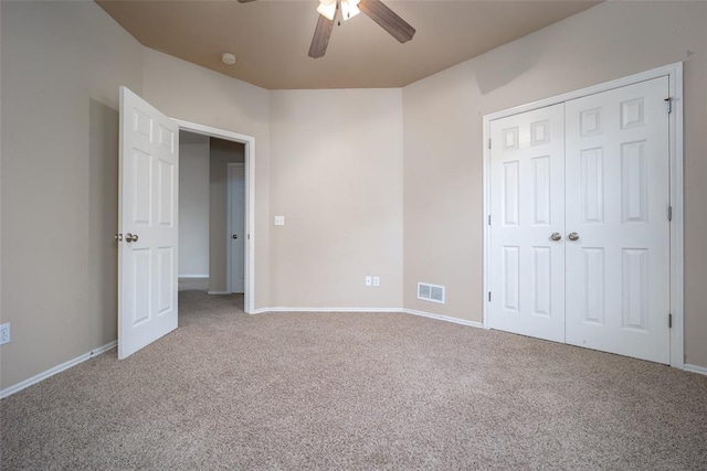 unfurnished bedroom with ceiling fan, a closet, and carpet floors