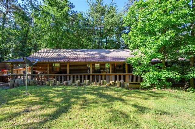 rear view of house featuring a yard