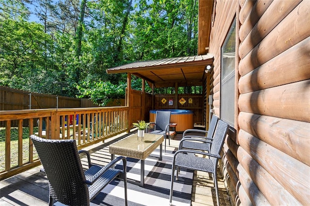 wooden terrace featuring a hot tub