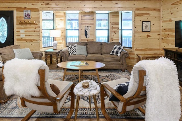 living room featuring wood walls and hardwood / wood-style floors