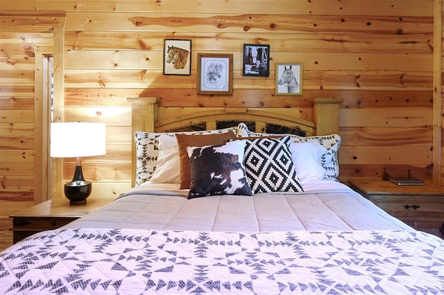 bedroom featuring wood walls