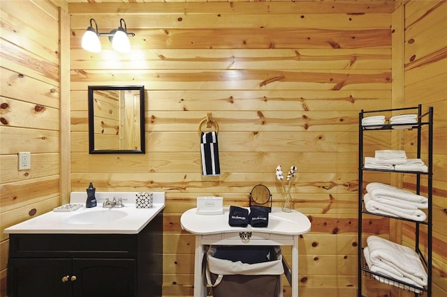 bathroom featuring vanity and wood walls