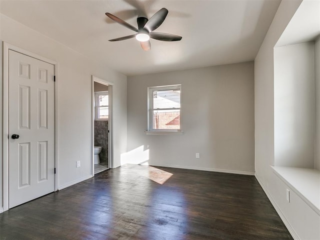 unfurnished bedroom featuring ceiling fan, dark hardwood / wood-style flooring, and ensuite bath