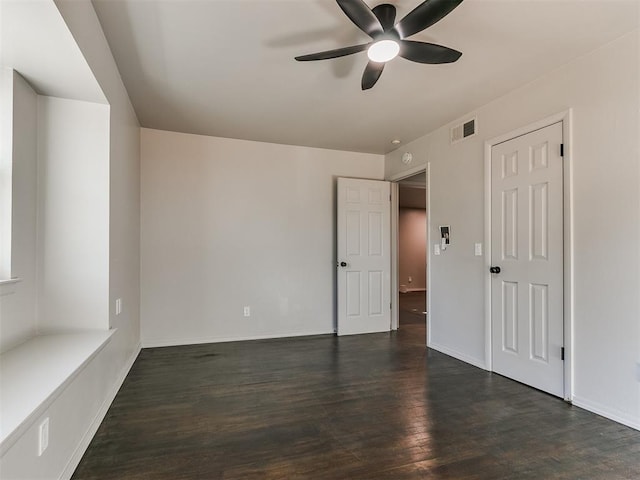 unfurnished room featuring ceiling fan and dark hardwood / wood-style flooring