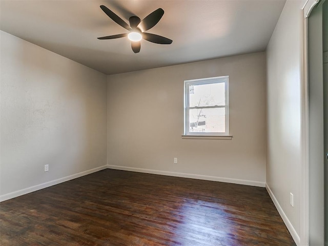 spare room featuring ceiling fan and dark wood-type flooring