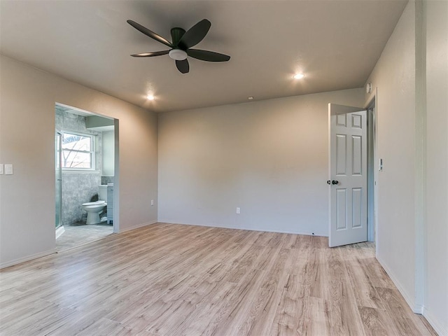 spare room with ceiling fan and light hardwood / wood-style floors