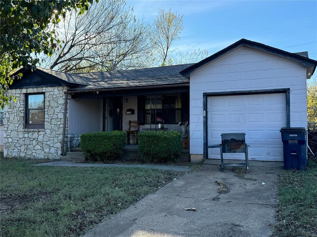 single story home with a porch and a garage