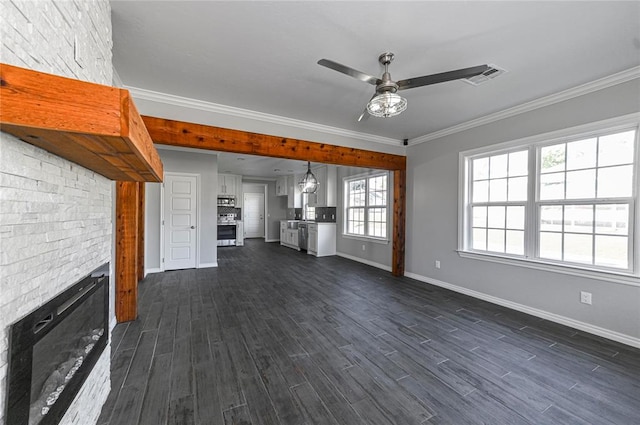 unfurnished living room with ceiling fan, ornamental molding, and dark wood-type flooring