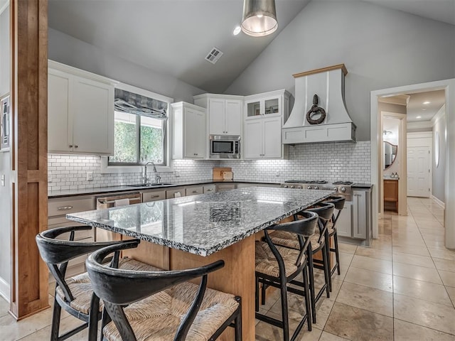 kitchen featuring white cabinets, a center island, and stainless steel appliances