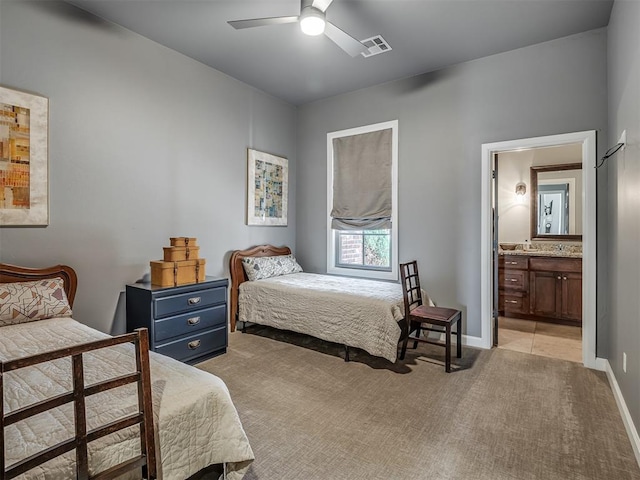 bedroom with ensuite bath, ceiling fan, and light carpet