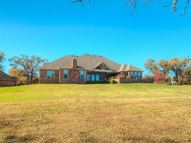 rear view of property with a yard