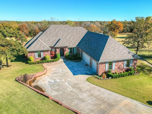 view of front of home with a front yard and a garage