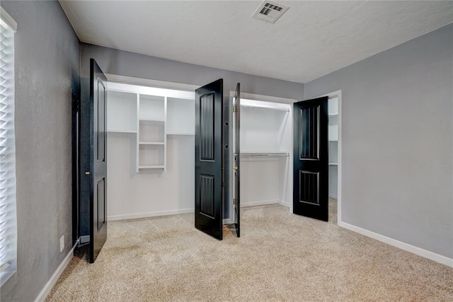 unfurnished bedroom featuring light colored carpet