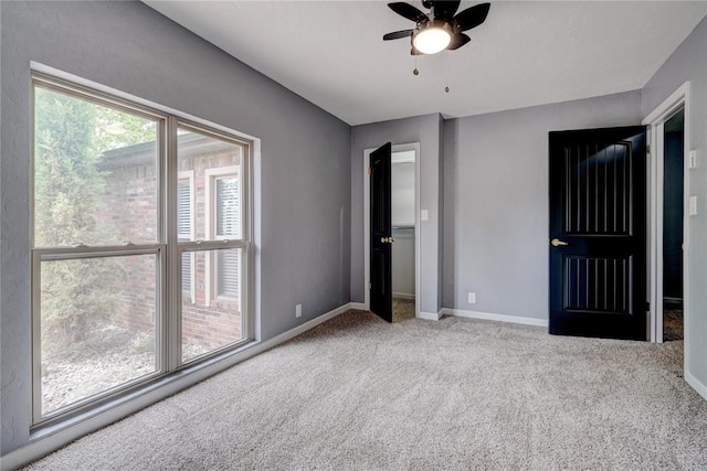 unfurnished bedroom featuring ceiling fan and light carpet