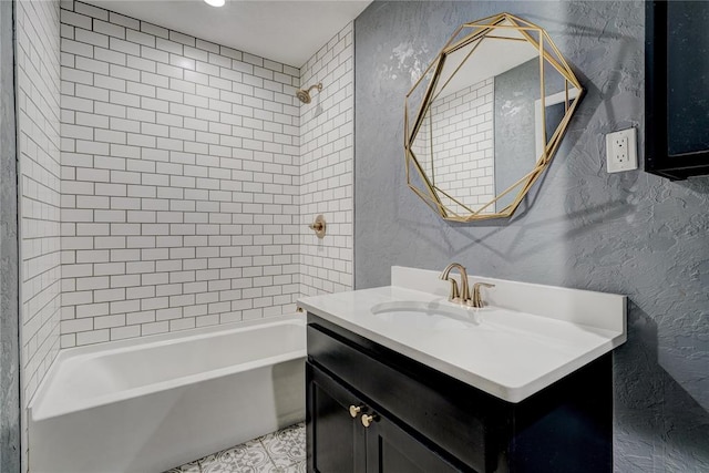 bathroom featuring vanity and tiled shower / bath