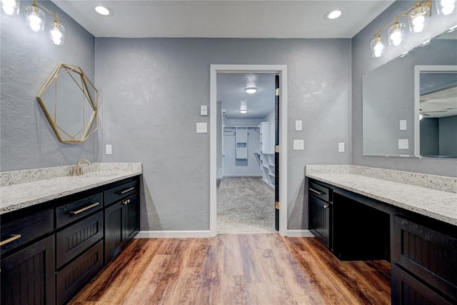 bathroom featuring ceiling fan, vanity, and wood-type flooring