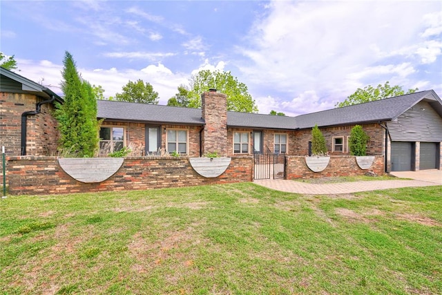 single story home featuring a front lawn and a garage