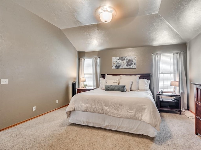 carpeted bedroom featuring vaulted ceiling