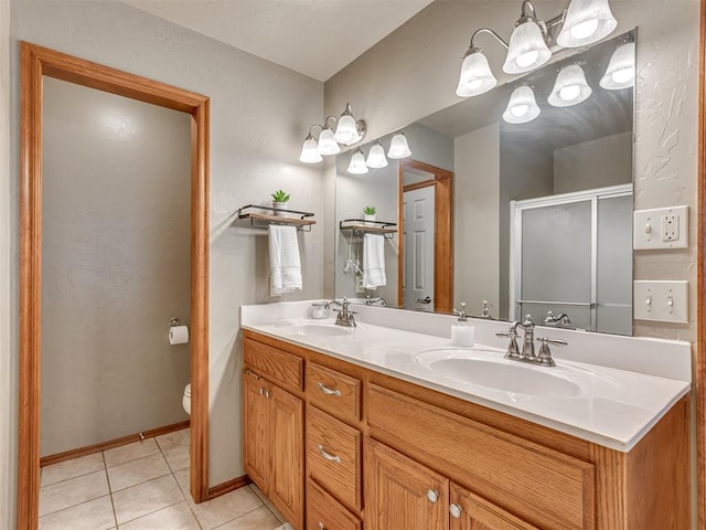 bathroom featuring toilet, vanity, tile patterned floors, and walk in shower