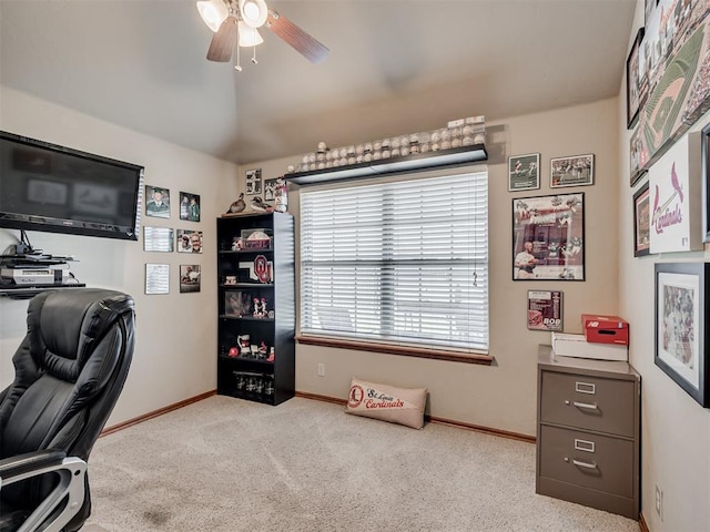 carpeted office space featuring ceiling fan